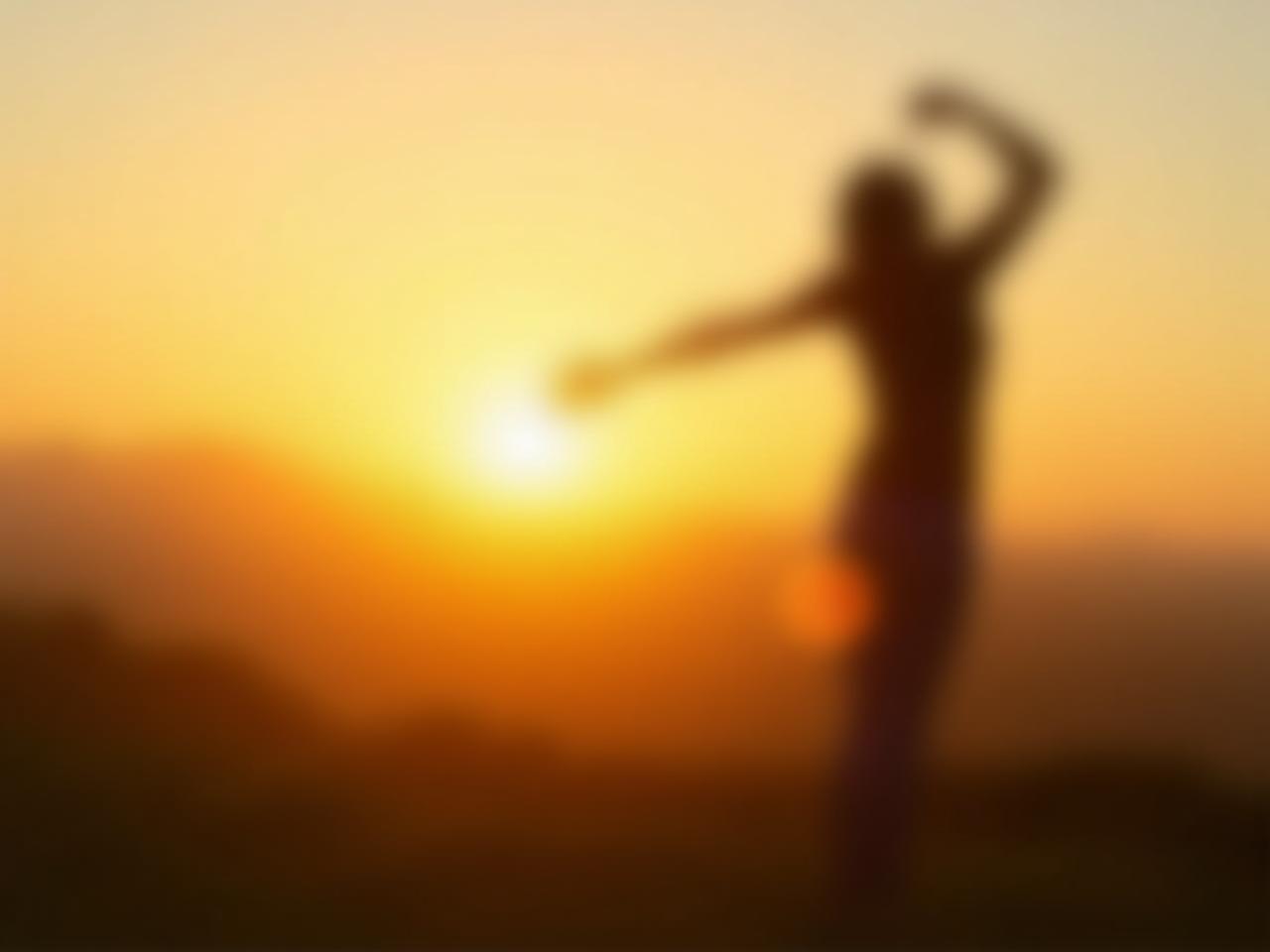A person exercising outdoors, with the sun setting in the background.