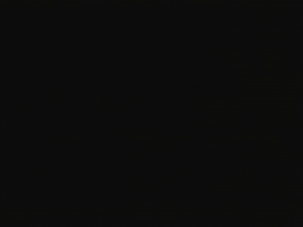 A person meditating in bed before sleep, focusing on breathing, surrounded by a calm and dark environment.